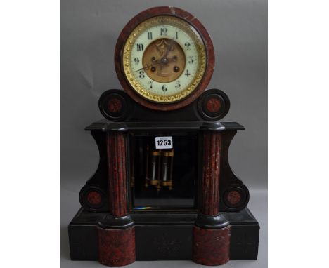 A Victorian black slate and rouge marble inlaid mantel clock, the drum case with visible brocat escapement, over a glazed pen