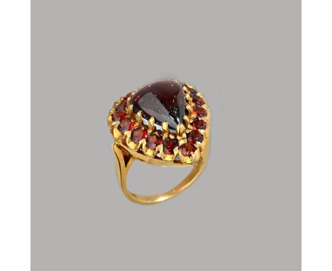 A 9ct gold and garnet cluster ring, claw set with the carbuncle garnet to the centre, in a surround of circular cut garnets, 