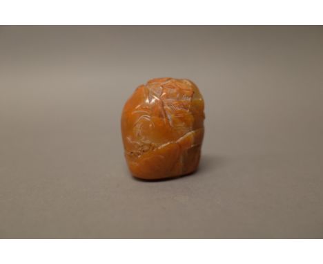 A Chinese brown soapstone boulder seal, probably 18th century, carved on one side with buildings, a fence and a bridge, the r