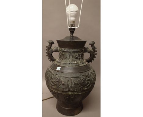 A large Chinese bronze archaistic two-handled baluster vase adapted as a lamp, probably late 19th century, cast with bands of