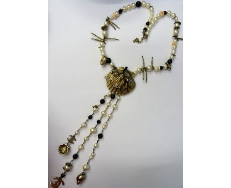 A Sautoir Chanel, Cruise Collection, 2005, designed as a gilt metal seashell pendant with applied black enamel and paste set 