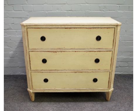 An early 20th century continental cream painted three drawer commode on tapering channelled square supports, 90cm wide x 86cm