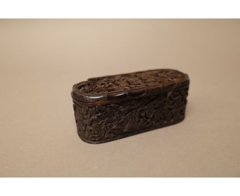 A Canton tortoiseshell oblong snuff box and hinged cover, 19th century, the cover, sides and base carved with figures, pavili