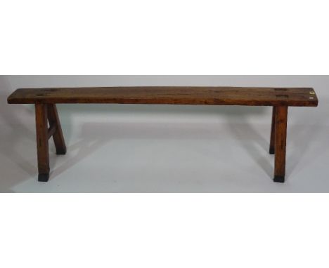 A 19th century fruitwood trestle ended bench, 161cm wide x 45cm high.