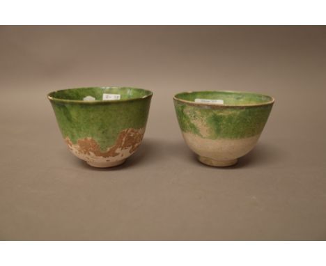 Two  Chinese pottery teabowls, Tang dynasty, each interior and part of exterior glazed in green, largest 6.5cm. high, (2). 