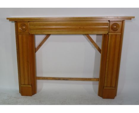 A 20th century beech fire surround with fluted decoration, 158cm wide x 115cm high, aperture 94cm wide x 93cm high. 