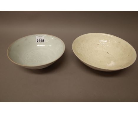 A Chinese qingbai glazed bowl, Song dynasty, the interior carved with a peony beneath a light blue transparent glaze, 17cm. d
