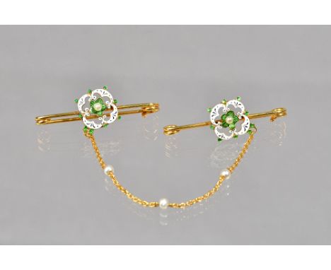 A pair of gold, green, black and white enamelled and seed pearl set bar brooches, connected by a gold chain, spaced with thre