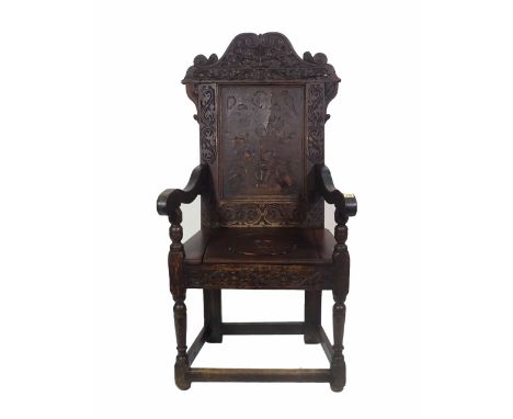 An 18th century and later oak open arm commode chair with carved back. 