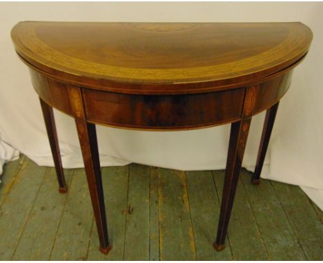 A Regency mahogany and satinwood inlaid demilune card table on four tapering rectangular legs, 74 x 94cm