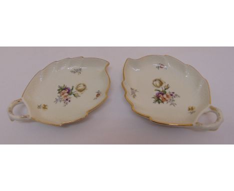 A pair of Royal Copenhagen bonbon dishes in the form of leaves decorated with floral sprays, marks to the base, 18cm (w)