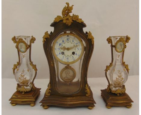 A French 19th century clock set, the clock with enamel dial Arabic numerals, the pendulum with miniature to the centre flanke