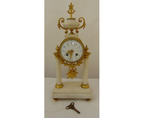 A French 19th century ormolu and white marble striking mantle clock with white enamel dial, Arabic numerals, two train moveme