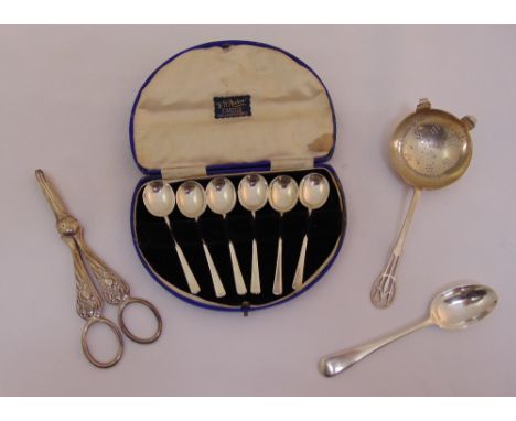 A quantity of hallmarked silver to include a pair of grape scissors by James Dixon 1915, a tea strainer by James Dixon 1944 a