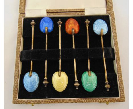 A cased set of six silver gilt and coloured enamel coffee spoons, Birmingham 1927