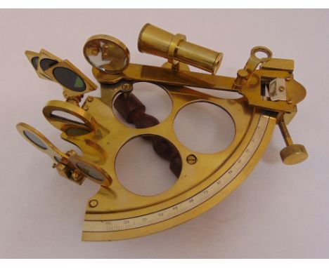 A brass naval sextant of customary form with turned wooden handle, 23 x 17cm