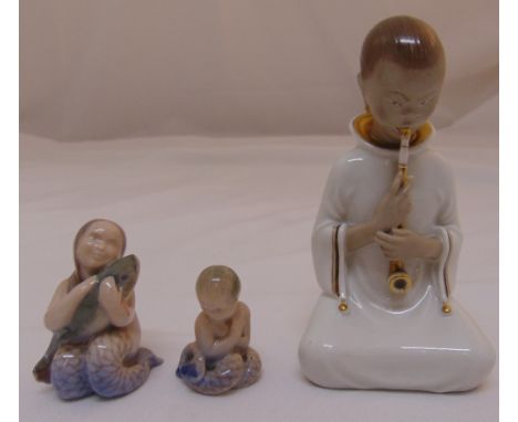 A Royal Copenhagen figurine of smoking girl (2342) by Arno Malinowski, a mermaid with fish (2348) and a miniature mermaid (23