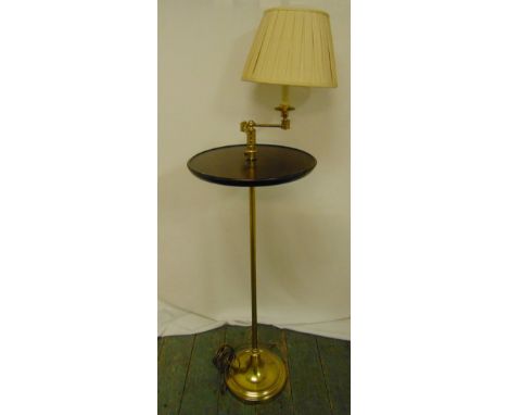 A brass and mahogany side table, circular on tubular stem with raised circular base and adjustable lamp with silk shade, 124c