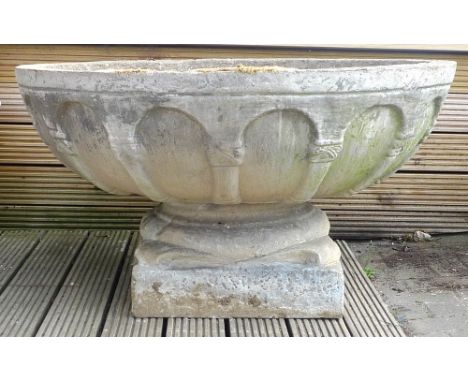 A cast concrete circular planter, with moulded decoration, on separate square section short pedestal base, 99.5 by 54cm high.