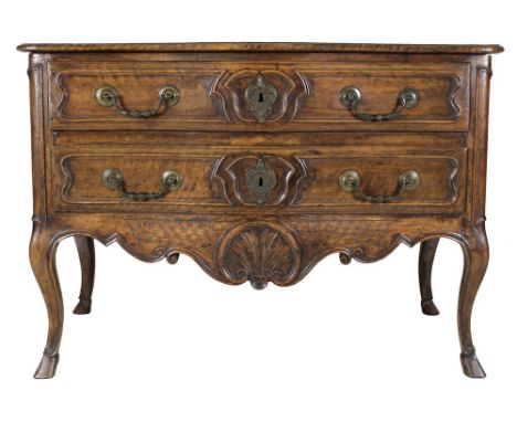A French Louis XV walnut commode of arc en arbalet outline, mid 18th century, moulded surface over two shaped panelled drawer