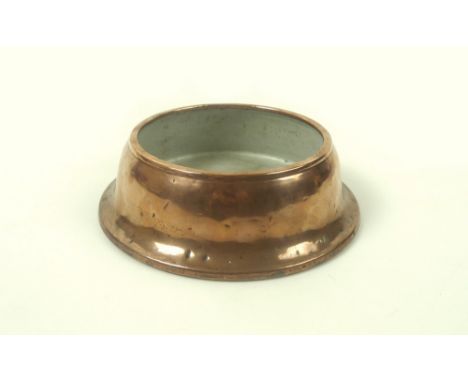 An early 20th century copper dog bowl, pale grey enamel interior and a metal plate base, marked J&A Bratt, Wolverhampton, 18 