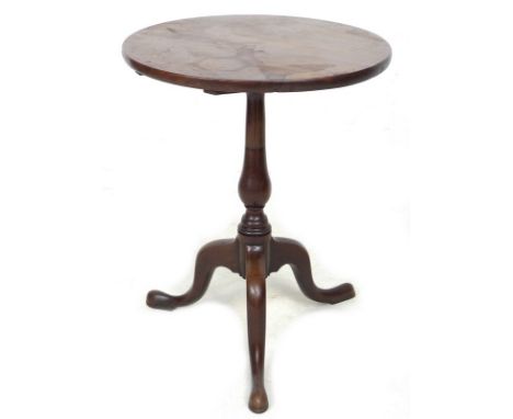 A 19th century mahogany tilt top occasional table, raised on turned baluster column, tripod base and pad feet, 45 by 58.5cm h