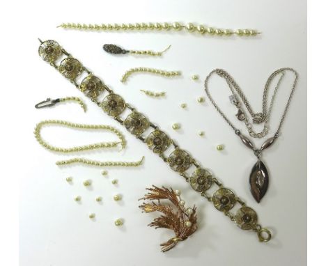 A small group of jewellery,comprising a 9ct gold and seed pearl spray brooch, 6.6g, a silver filigree floral bracelet with re