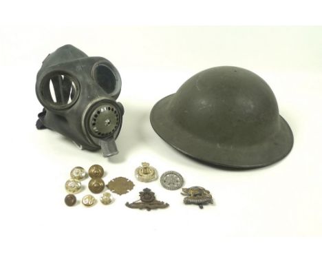 A 1940 WWII K28 metal helmet, a 'Normal' II D K.C.O. stamped gas mask, plus a small quantity of cap badges and buttons. (14)