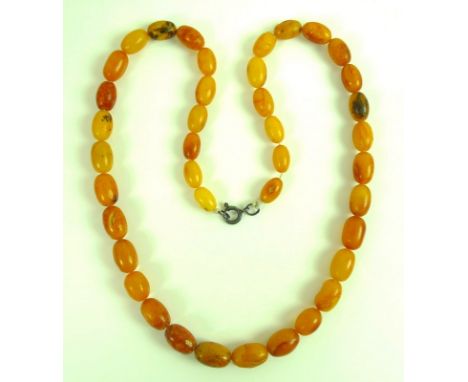 A set of vintage butterscotch amber beads, with silver clasp, graduated beads range from 11.6mm long to 15.4mm, 24.6g.