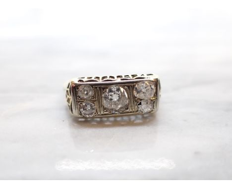 A Diamond five stone Ring pavé-set old-cut stone (chipped) between two pairs of smaller stones, stamped 18ct, ring size N 1/2