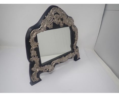 An Edward VII silver mounted Easel Mirror with floral and scroll embossing, London 1908, maker: W. Comyns, worn 