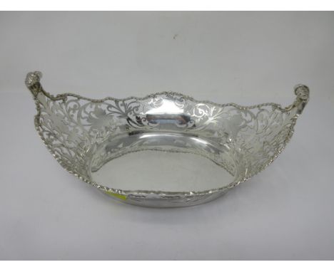 A George V silver pierced oval Basket with rope twist border and scroll finials, London 1928, 490gms 