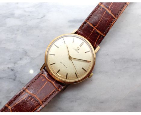 A gentleman's Omega Geneve Wristwatch the champagne dial with hourly baton markers and sweep seconds hand in 9ct gold case, c