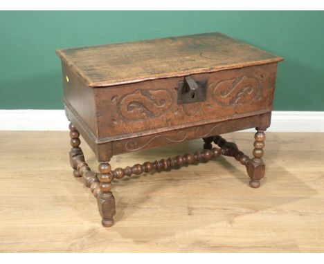 An 18th Century oak Bible Box on Stand with hinged top, carved front on bobbin turned supports and stretchers 2ft 2in W x 1ft