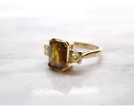 A Zircon and Diamond three stone Ring corner claw-set yellow/brown zircon between two old-cut diamonds in 18ct gold, ring siz