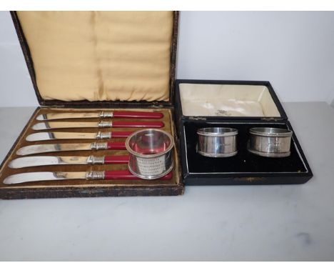 A heavy silver presentation Napkin Ring, Birmingham 1915, 72gms, a pair of Napkin Rings, Birmingham 1915, and six Tea Knives 