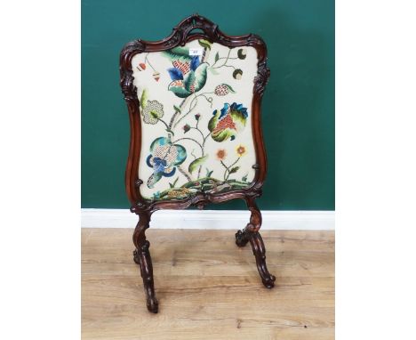 A Victorian walnut framed Screen with floral needlework panel mounted on cheval supports 3ft 6in H x 1ft 10in W 