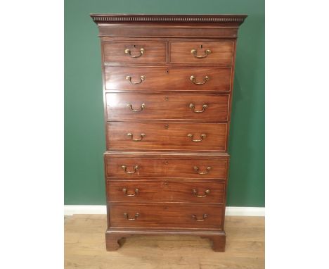 A 19th Century mahogany Chest on Chest with carved dentil cornice above two short and six long drawers on bracket feet, 6ft 2