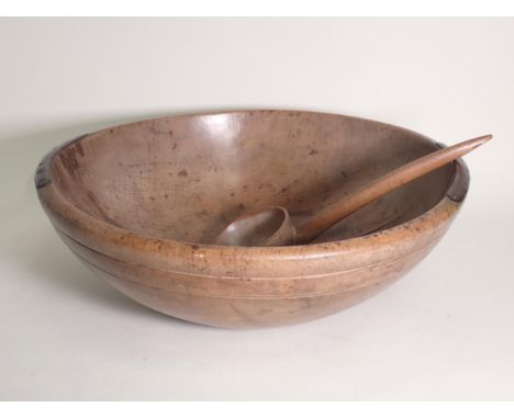 A 19th Century large Sycamore Dairy Bowl with incised line decoration, 21in diam x 6½in H, with sycamore ladle, repaired 