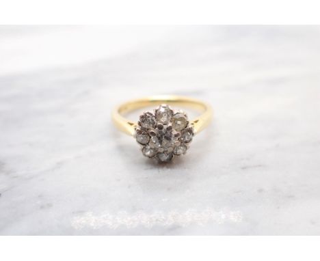 A Diamond Cluster Ring claw-set old-cut stone within eight smaller stones in 18ct gold, ring size N 1/2 
