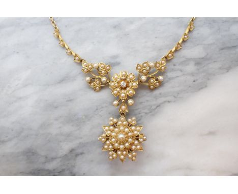 A Victorian Diamond and Seed Pearl Necklace with flowerhead plaque set old-cut diamond within pearl frame suspending detachab
