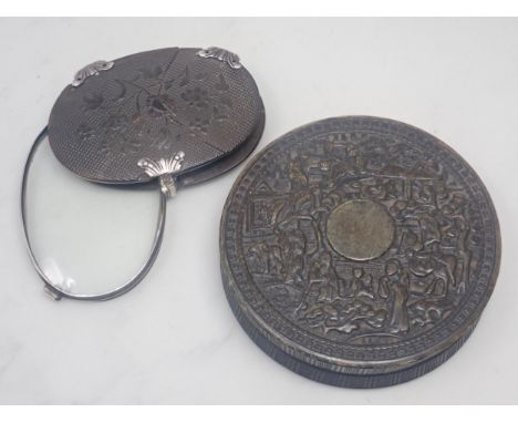 A 19th Century pressed tortoiseshell oval Magnifying Glass with floral carved decoration and white metal mounts 3in W and a 1