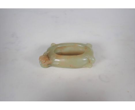 A Chinese Jade Brush Washer of oval form carved flower and leaves, approx 3in wide 