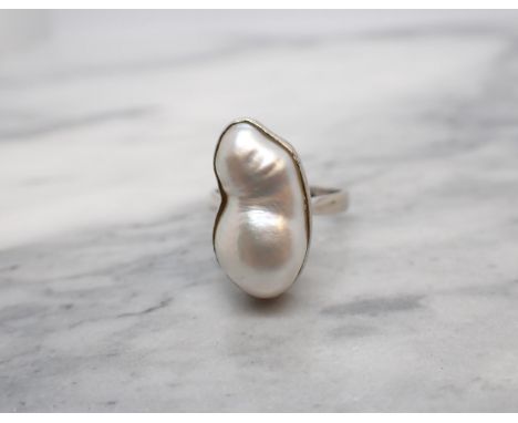 A contemporary Baroque Pearl Ring collet-set single pearl in white gold stamped 585, ring size K/L 