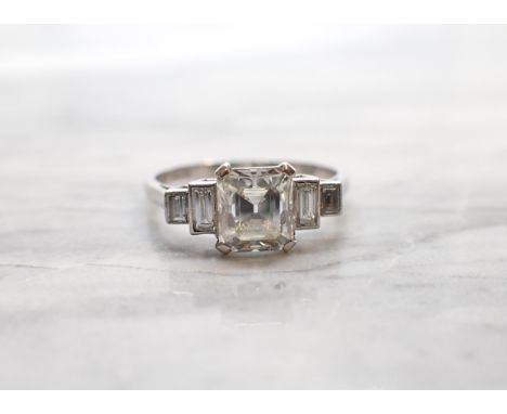 A Diamond Ring corner claw-set asscher-cut stone, estimated 1.20ct, between two pairs of baguettes in platinum, ring size M 