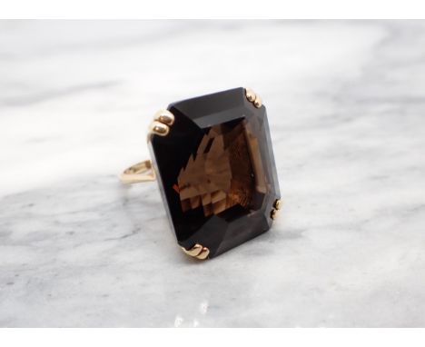 A large Smoky Quartz Dress Ring corner claw-set emerald-cut stone, stamped 18ct, ring size J, approx 19.90gms 