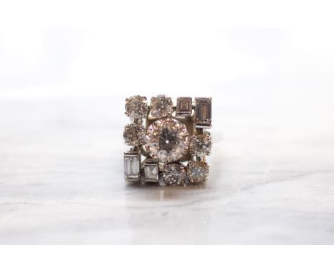 A mid 20th Century Diamond Cluster Ring claw-set old-cut stone within square frame formed by six brilliant-cut stones and fou