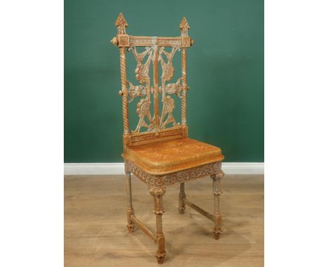 A Coalbrookdale cast iron Chair designed by Christopher Dresser, with pierced back, cast simulated button upholstered seat on