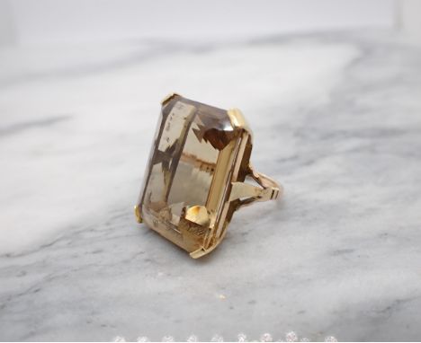 A large Citrine Dress Ring corner claw-set emerald-cut stone in pierced mount, unmarked, untested, ring size G, approx 11.20g