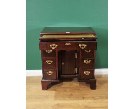 An early Georgian style mahogany kneehole Desk, with caddy top and fitted slide above frieze drawer, three drawers to either 